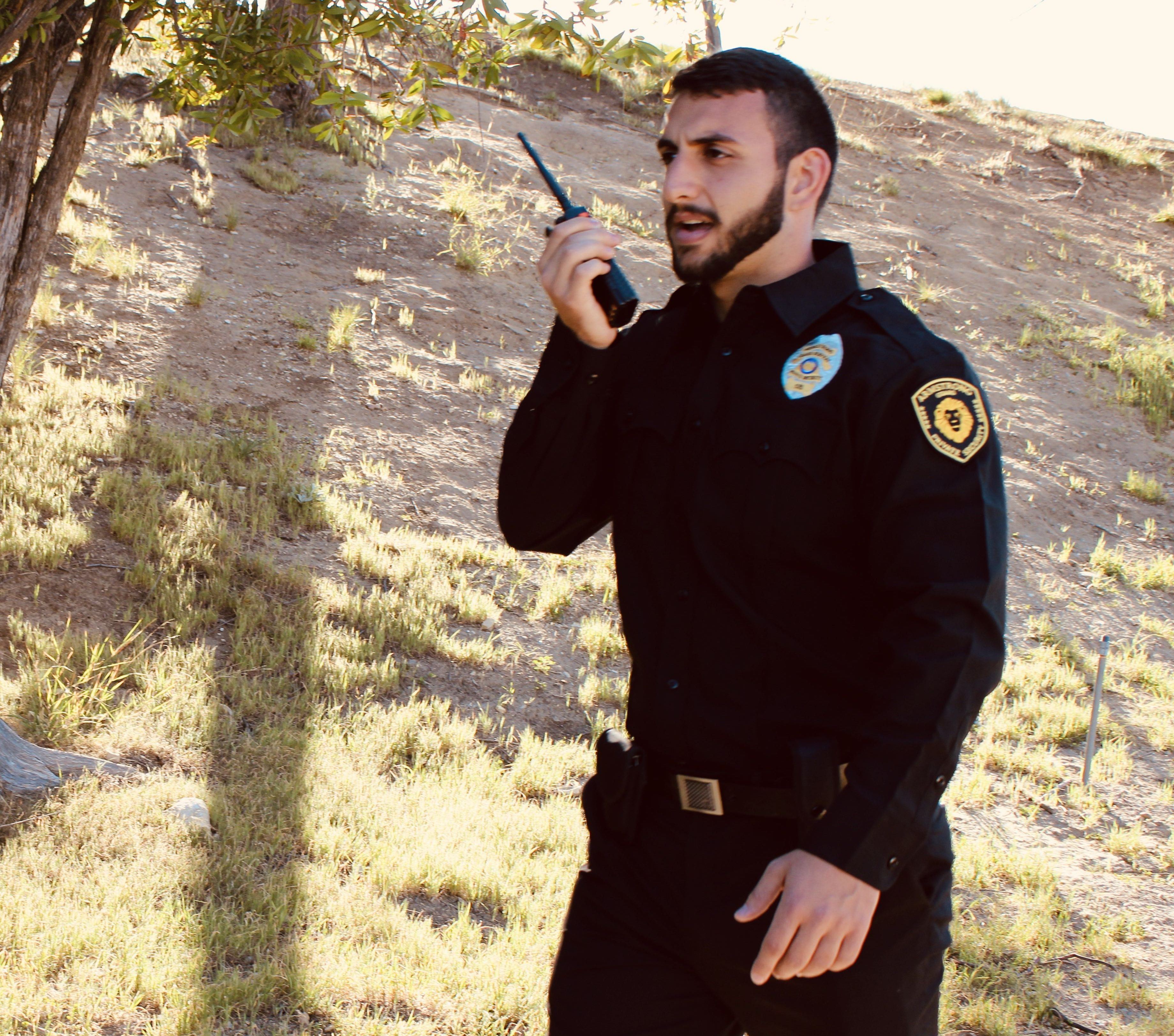 Image of the security guard on phone, Armstrong Security Guard Company Los Angeles