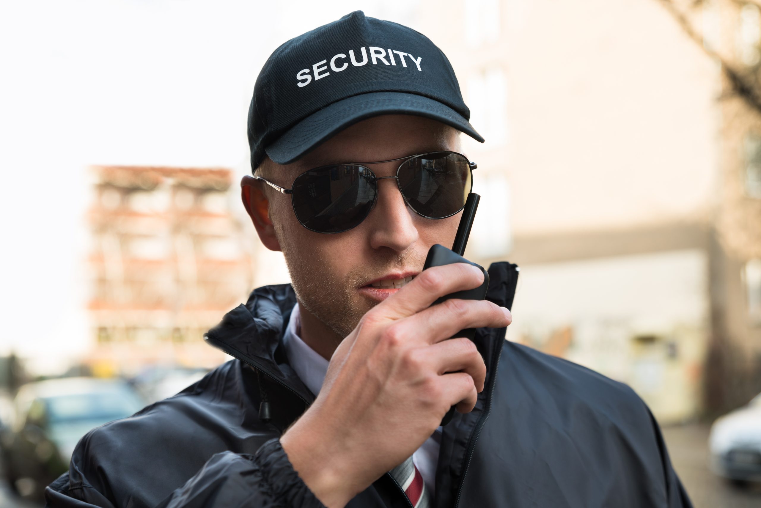 Security guard reporting over a walkie talkie, Performing security services in San Francisco